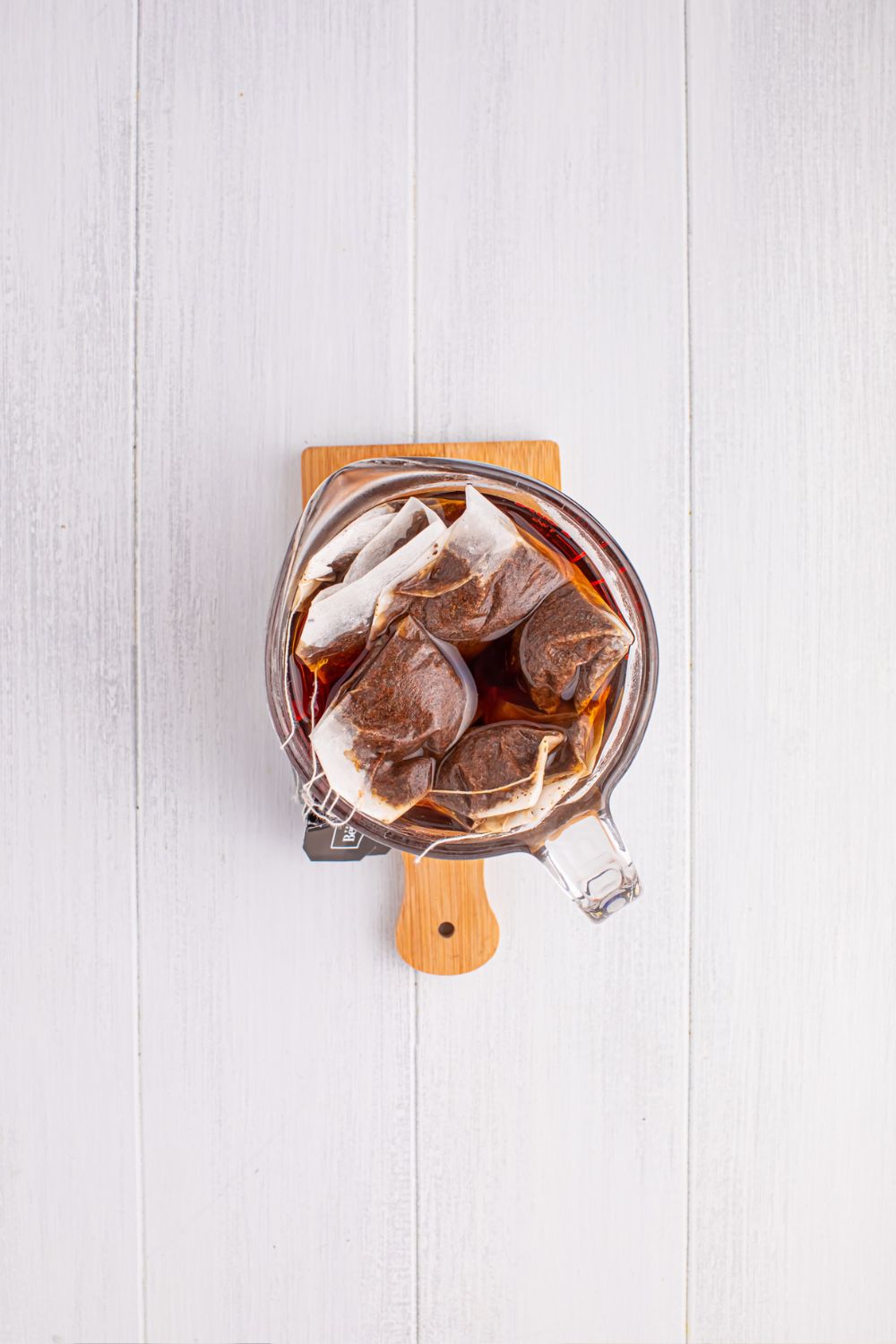 black tea steeping in a pitcher on table
