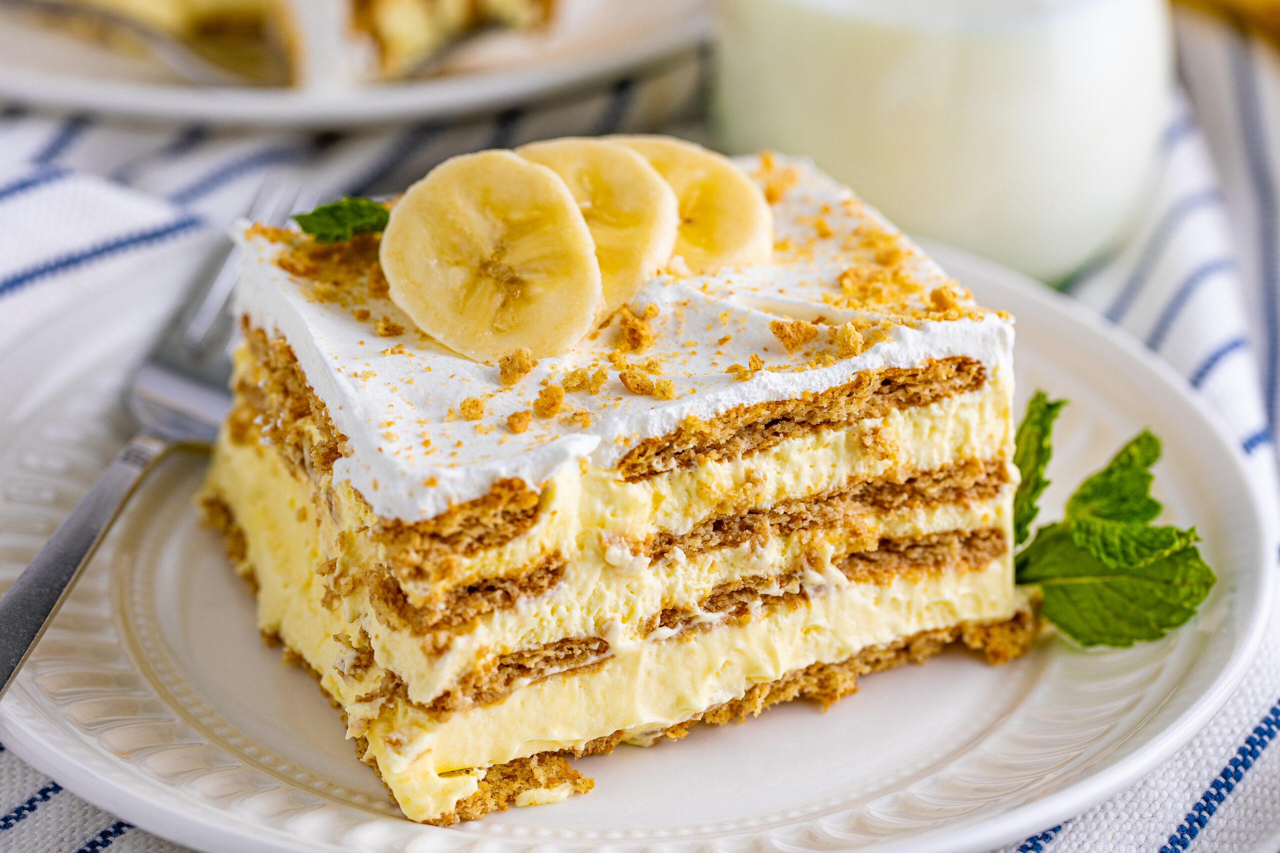 No Bake Banana Icebox Cake on a white place topped with sliced bananas
