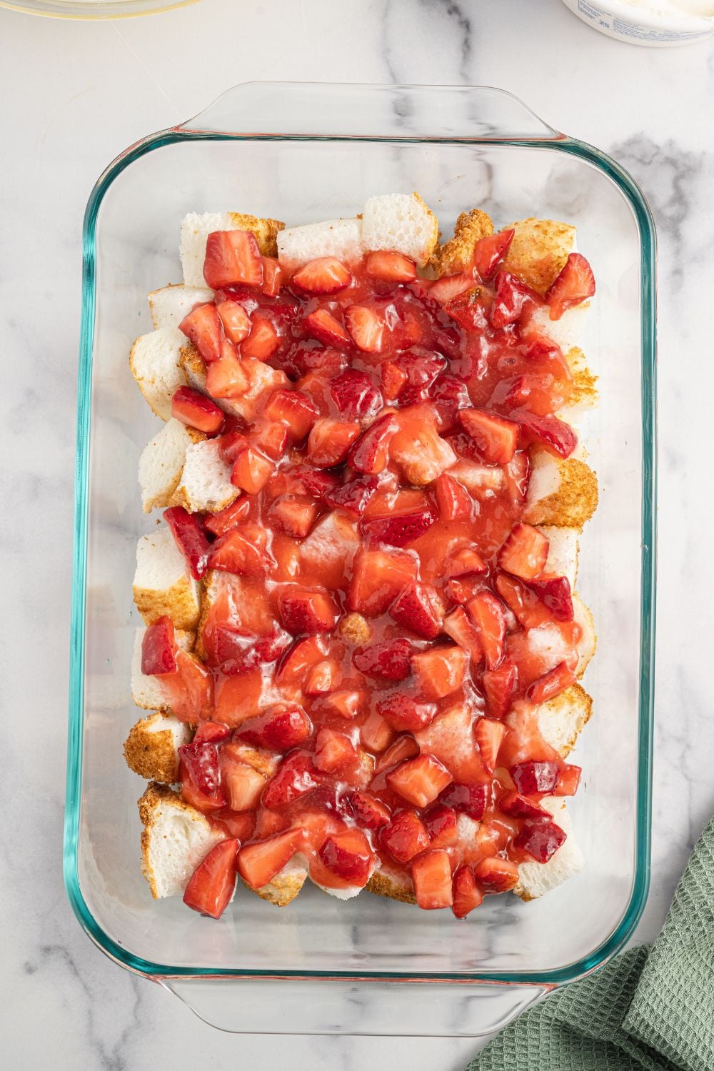 Strawberry Heaven On Earth Cake being layered in a pan,