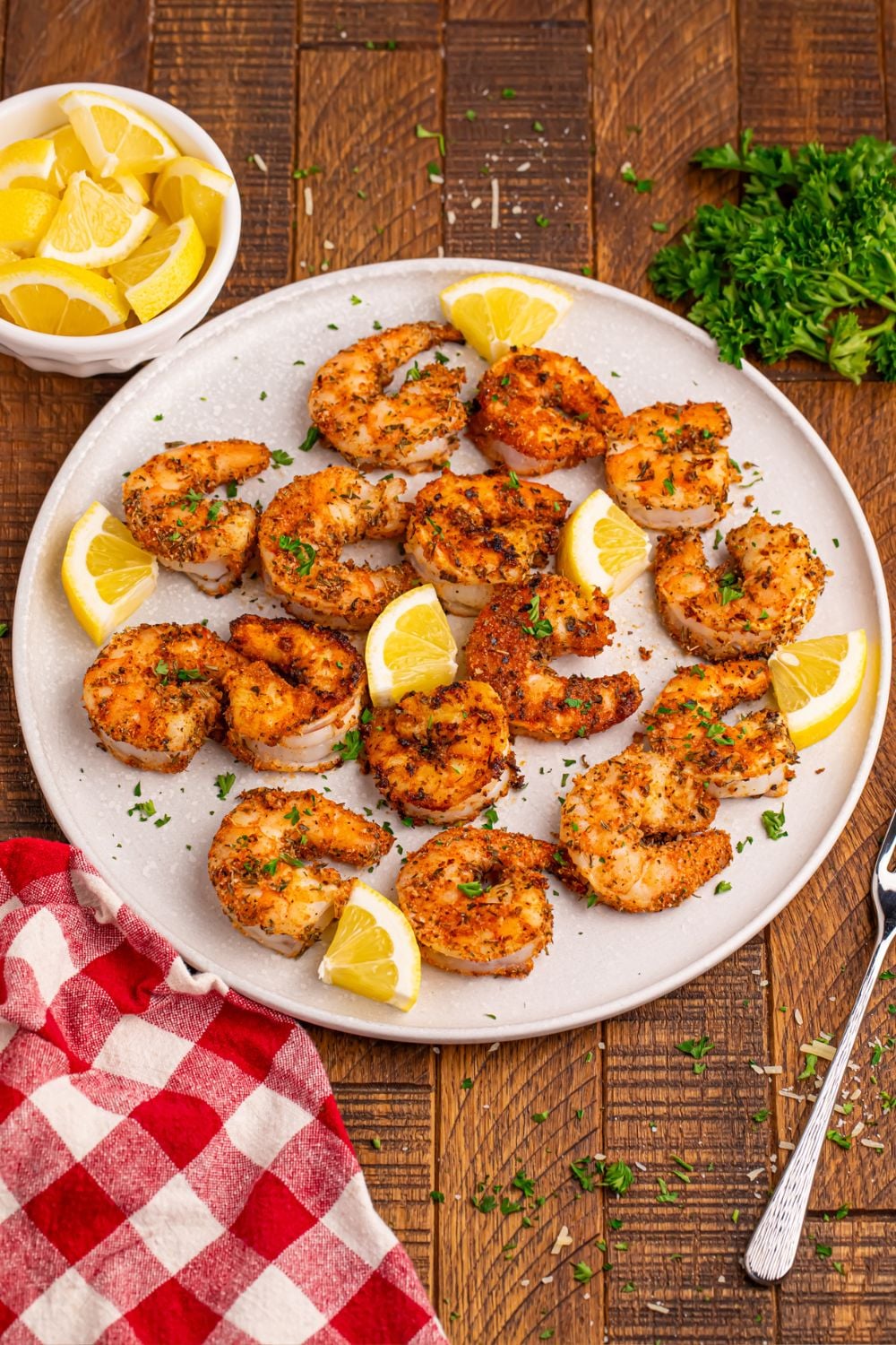 Cajun Grilled Shrimp on a plate with slices of lemons around it
