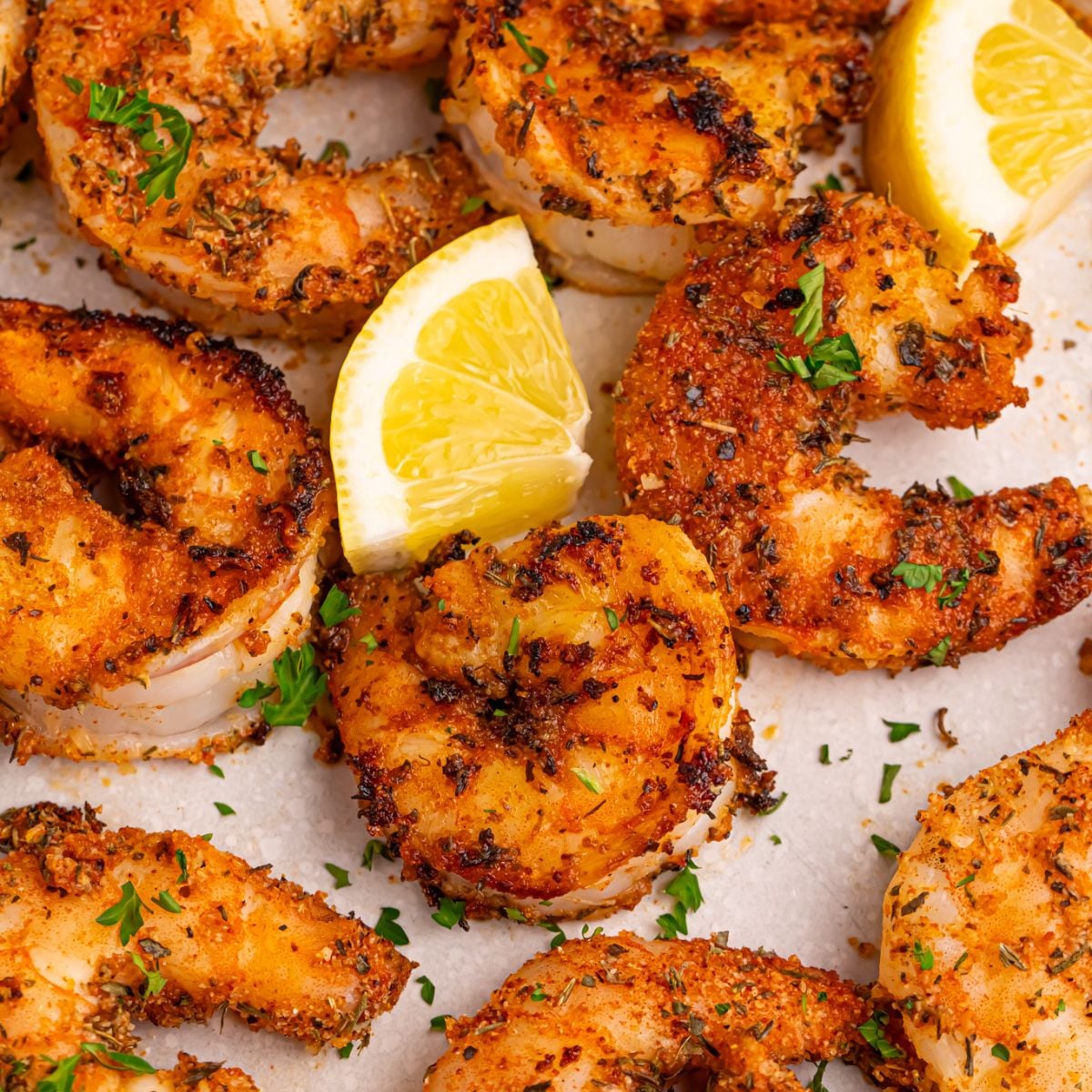 Cajun Grilled Shrimp on table with lemon slices on table