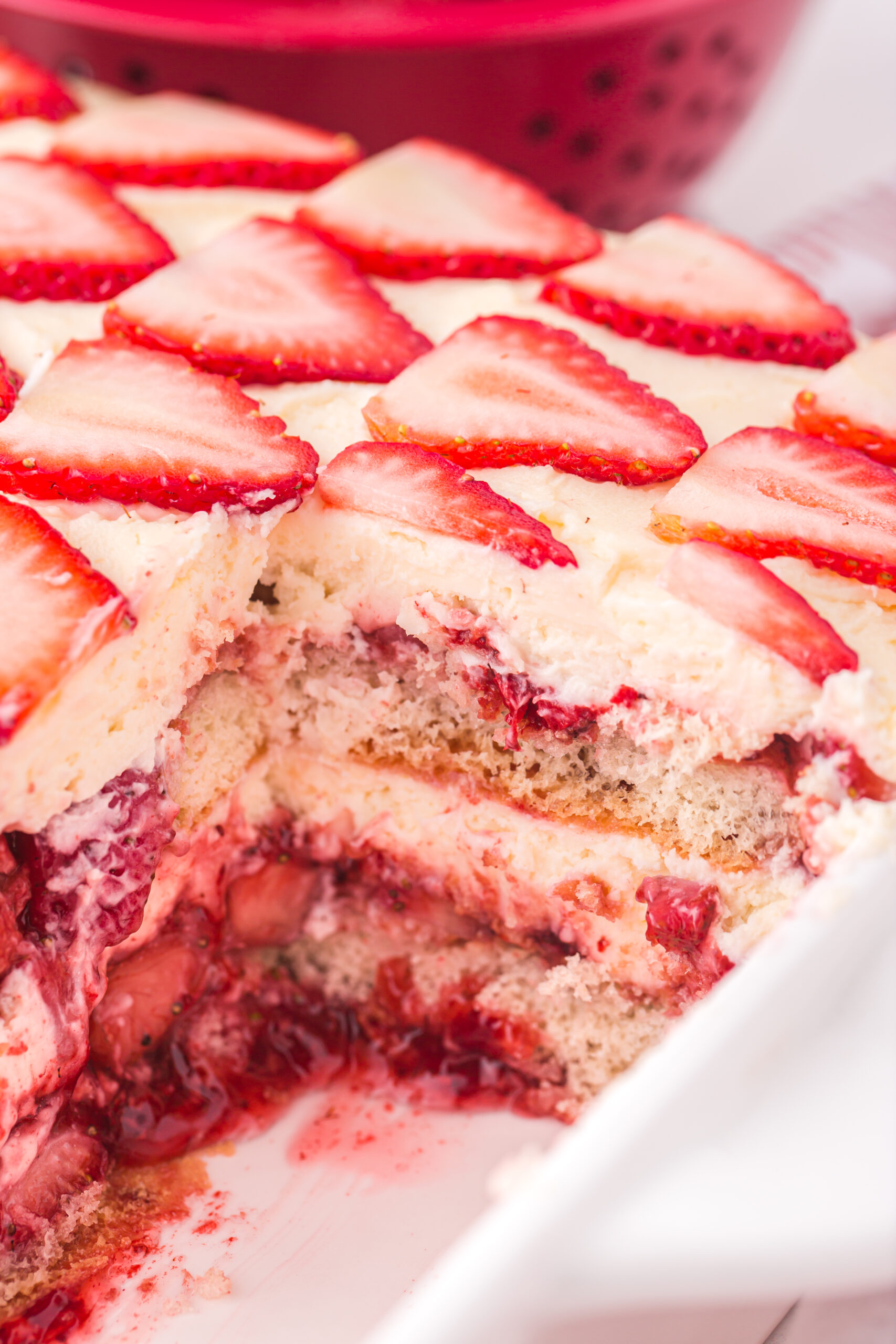Strawberry Tiramisu in a white baking dish with a slice removed