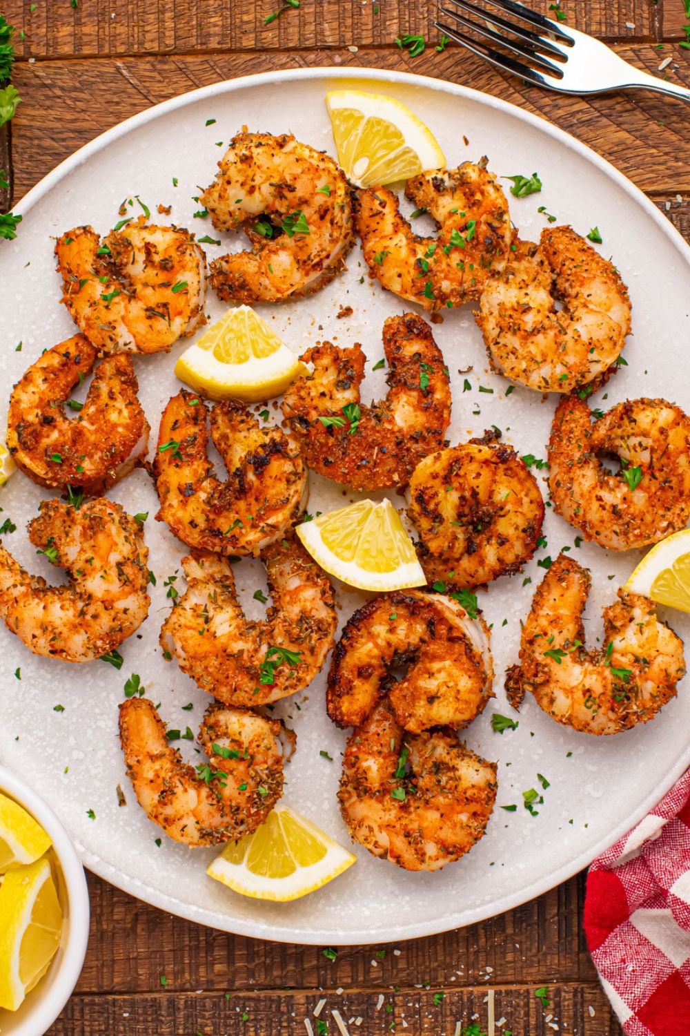 overhead shot of a plate on table with Cajun Grilled Shrimp scattered on it