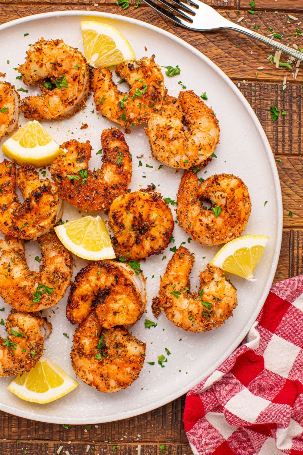 Cajun Grilled Shrimp on a plate showing the dry rub and lemon slices