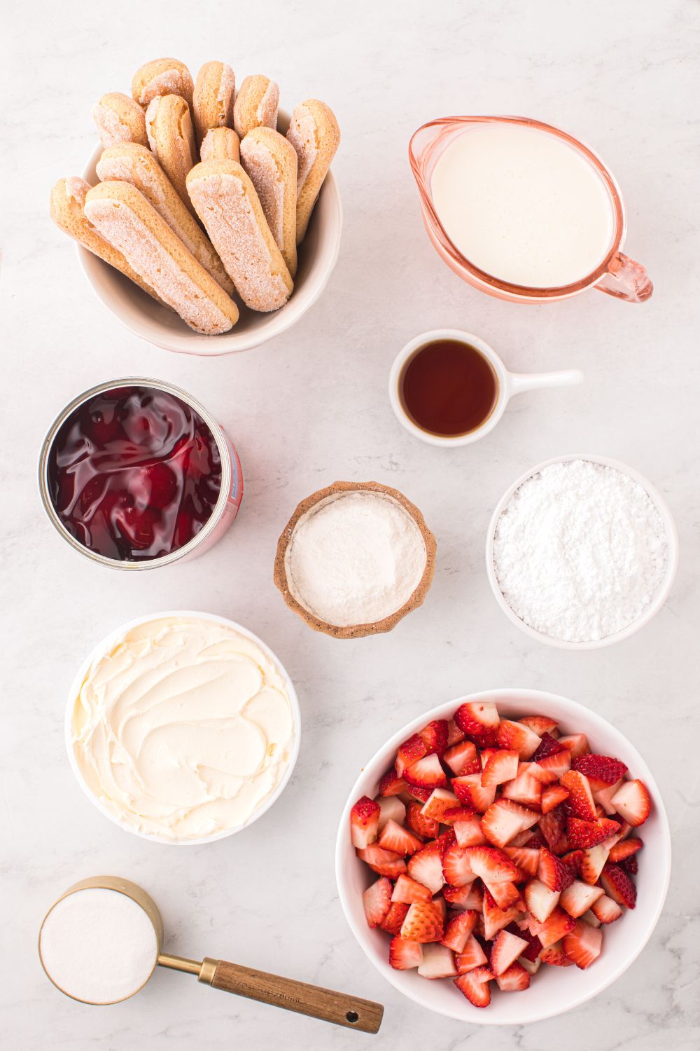 ingredients for Strawberry Tiramisu sitting on table in single served containers