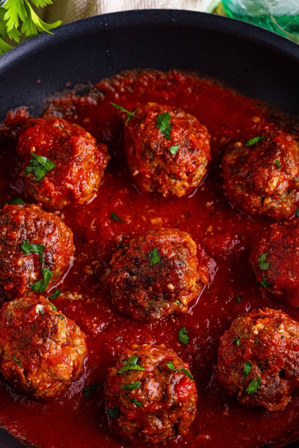 Classic Italian Meatballs in a sauce in a pan sitting on the counter 