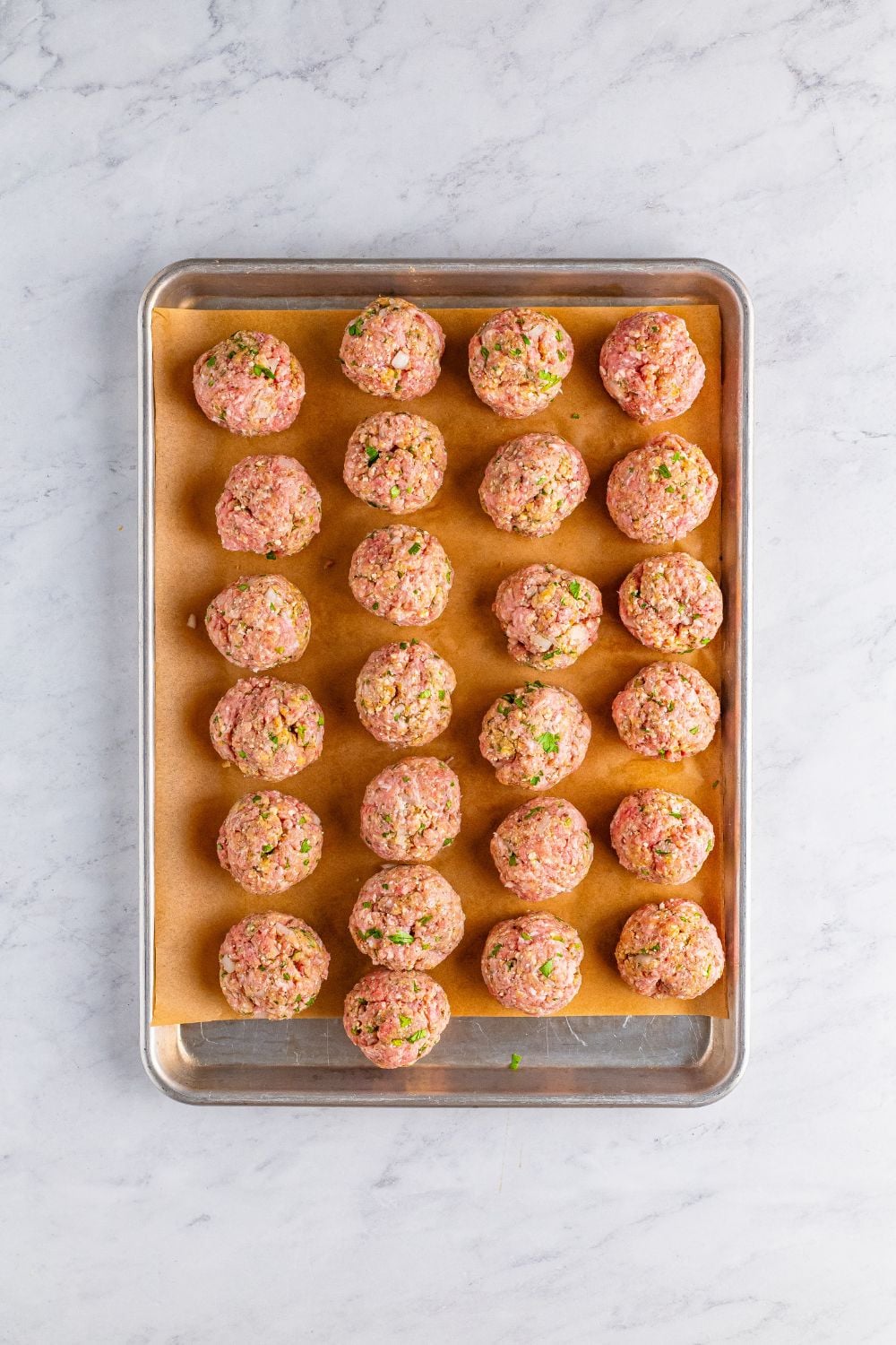 raw Classic Italian Meatballs on a baking tray 