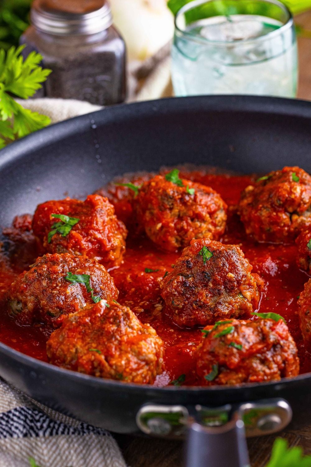 Classic Italian Meatballs in a black skillet on the table 
