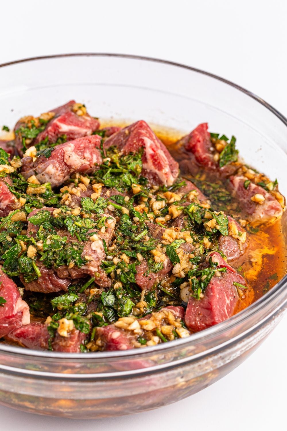 steak in a homemade marinade in a bowl sitting on counter