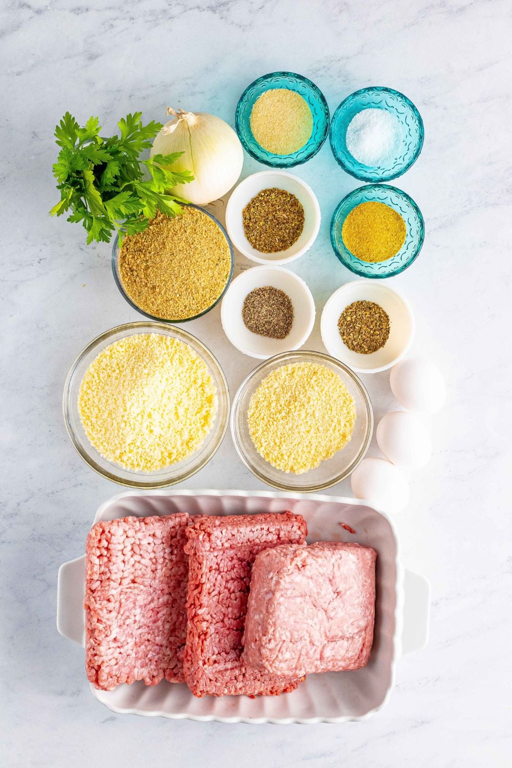 Classic Italian Meatball ingredients on a table with all the ingredients needed 