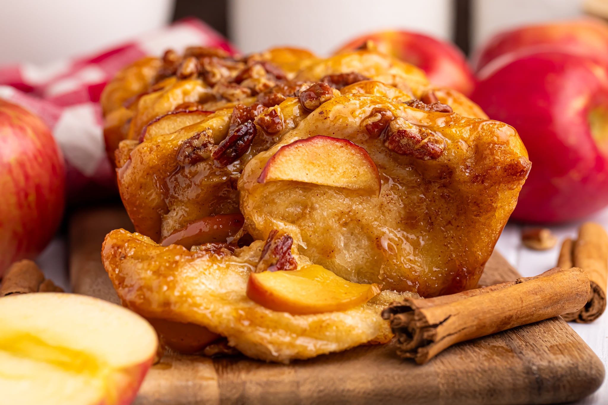 apple pie pull-apart bread with a slice removed on a wooden board