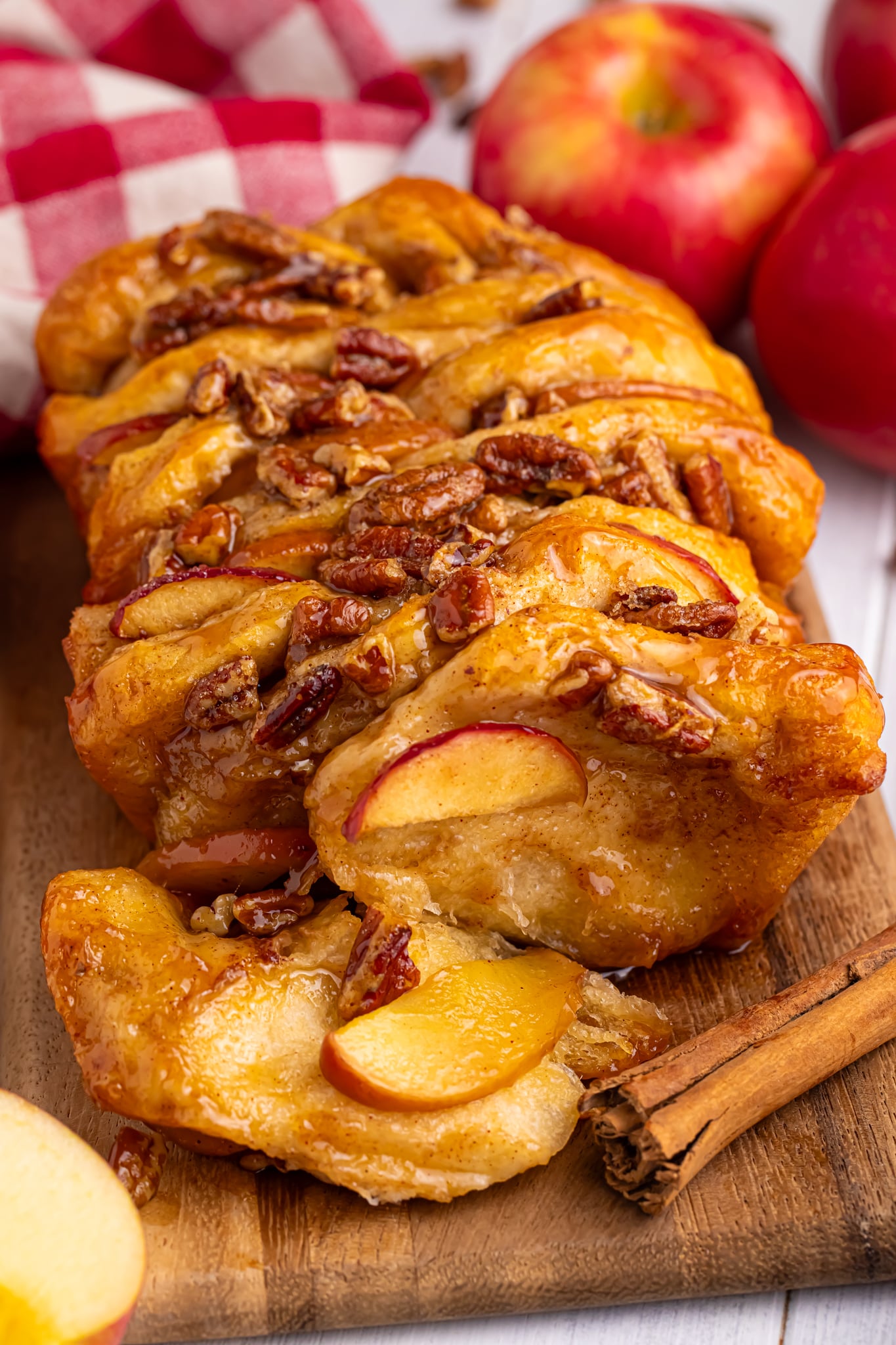 Apple Pie Pull Apart Bread sitting on table topped with nuts and caramel sauce