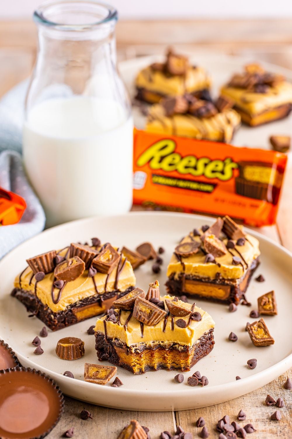 Reeses Stuffed Brownies on a plate with one brownie with a bite taken out of it