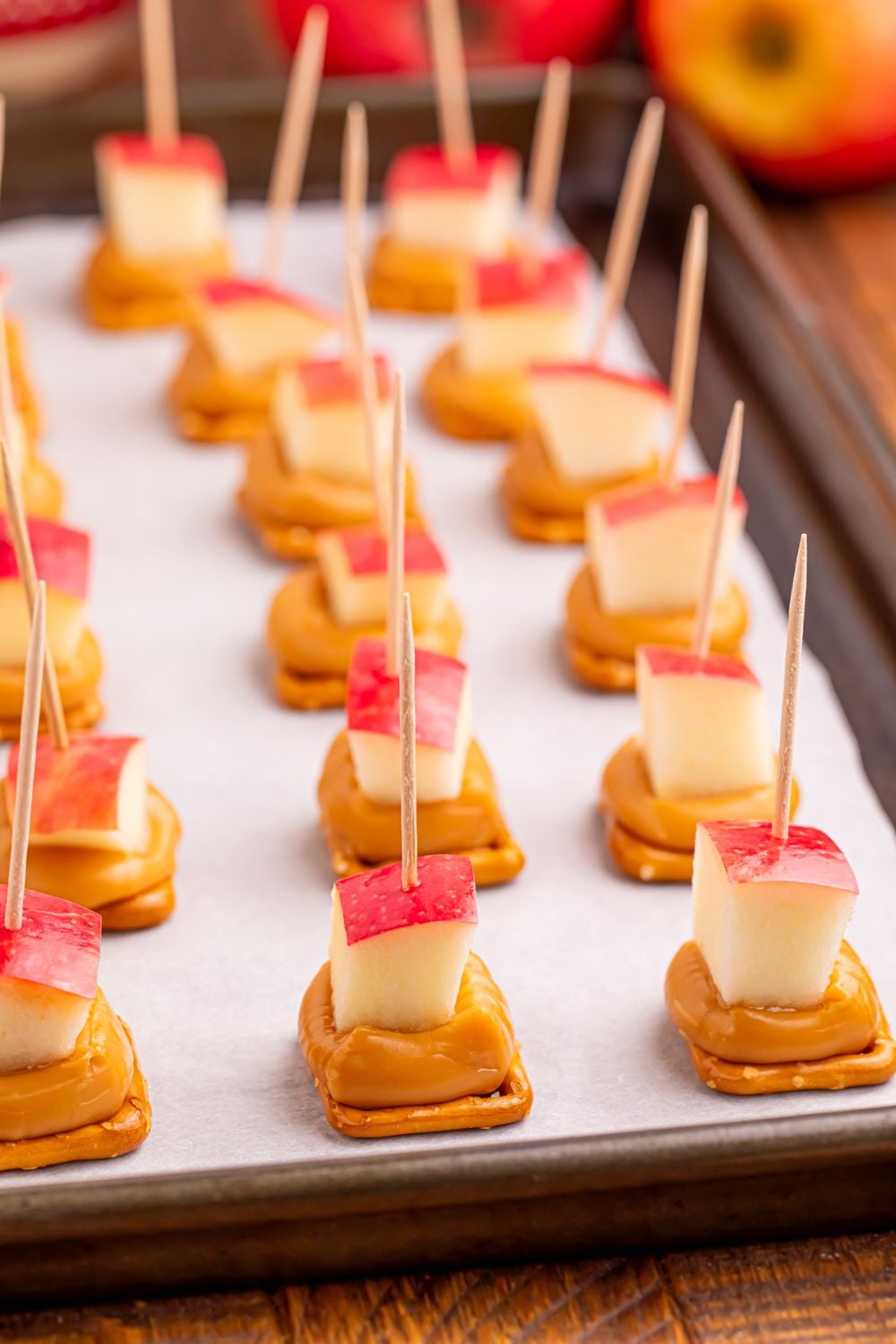 Caramel Apple Pretzel Bites on a baking sheet sitting on table