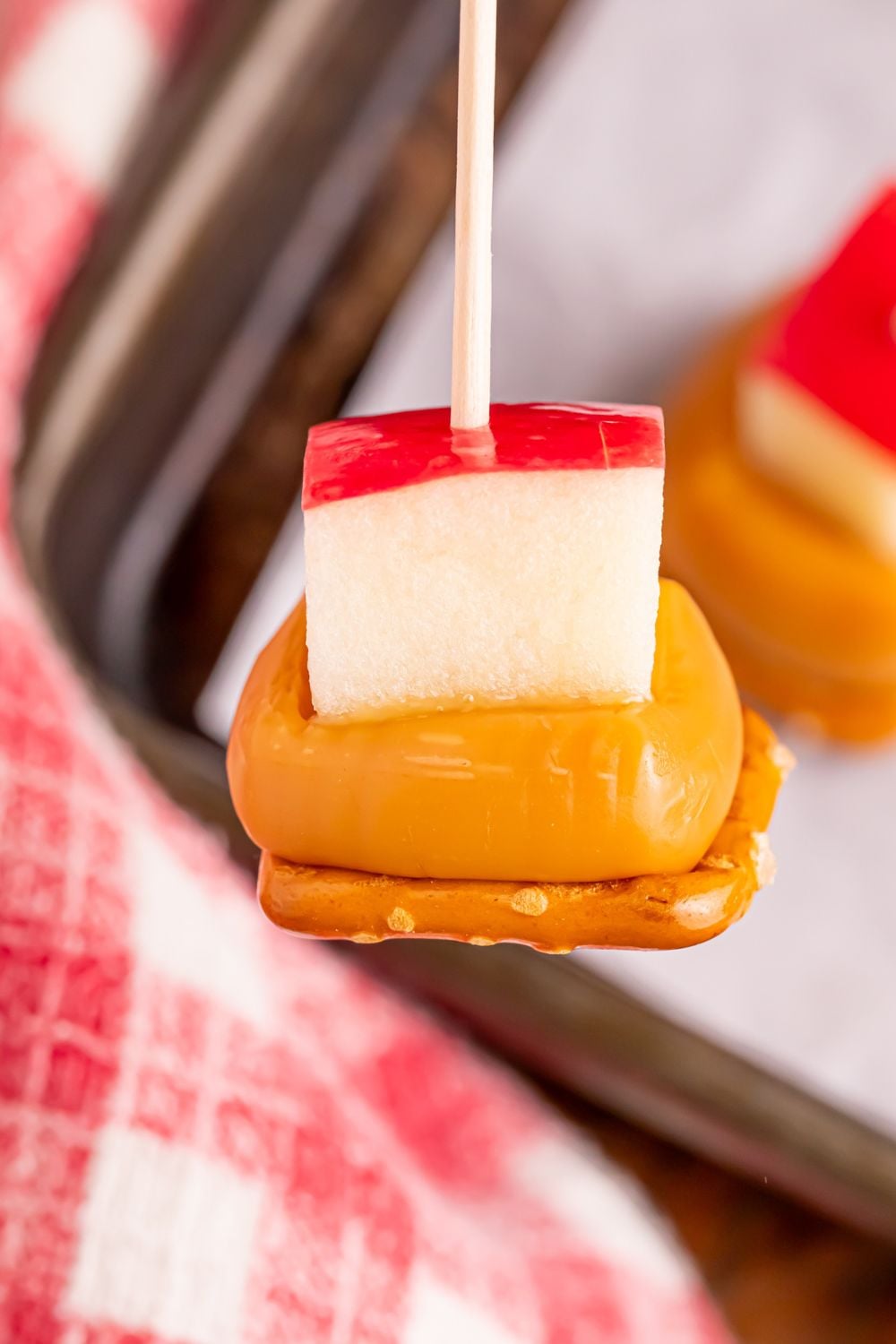 close up of a Caramel Apple Pretzel Bite on a stick