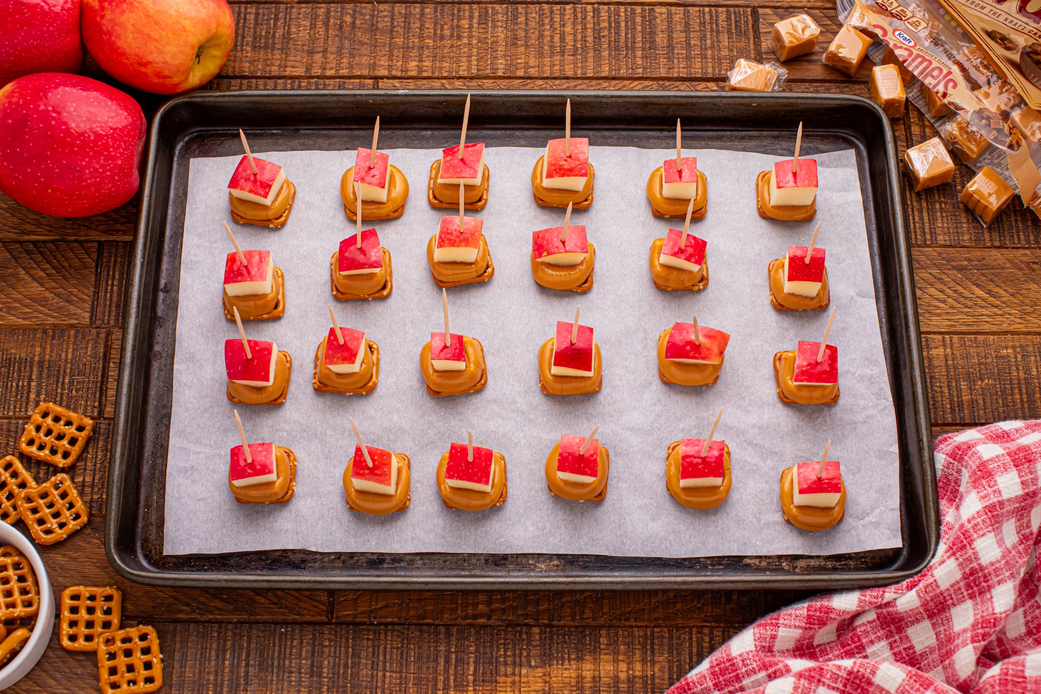 Caramel Apple Pretzel Bites on a cookie sheet with toothpick in each