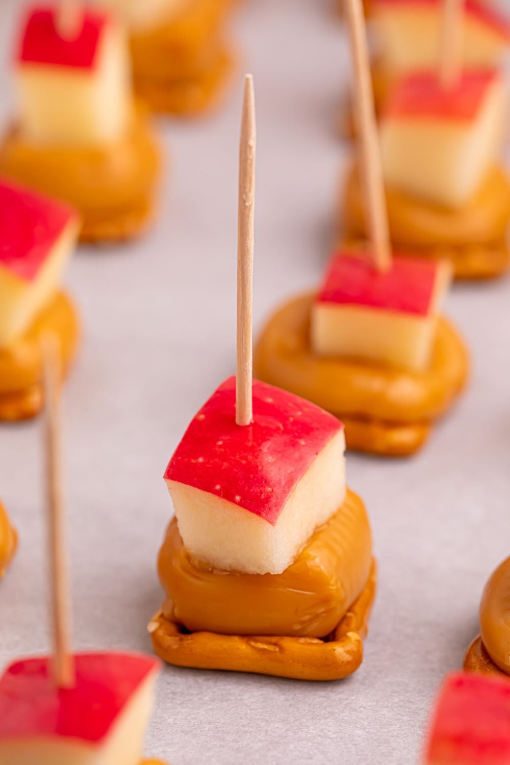 Caramel Apple Pretzel Bites on a parchment lined tray on table