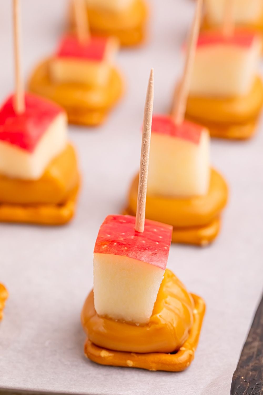 close up of caramel apple pretzel bites on cookie tray