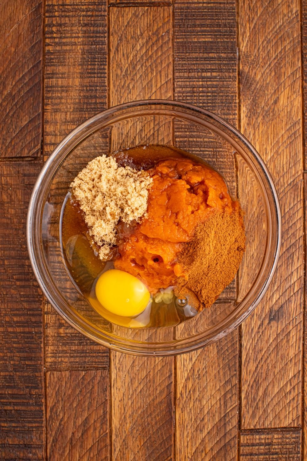 pumpkin mixture for pumpkin pie filling for Pumpkin Pie Cinnamon Roll Cups in a glass bowl on table