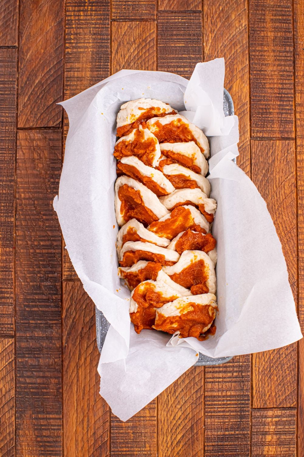 Pumpkin Pie Pull Apart Bread in raw form in a pan on table 