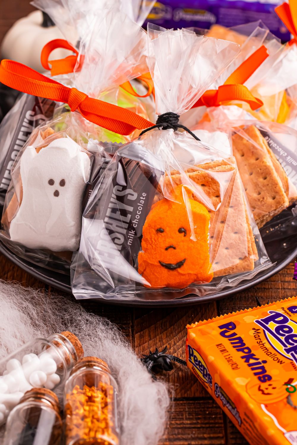 Halloween Smores Gift Bags in a black bowl sitting on table with package of peeps on table 
