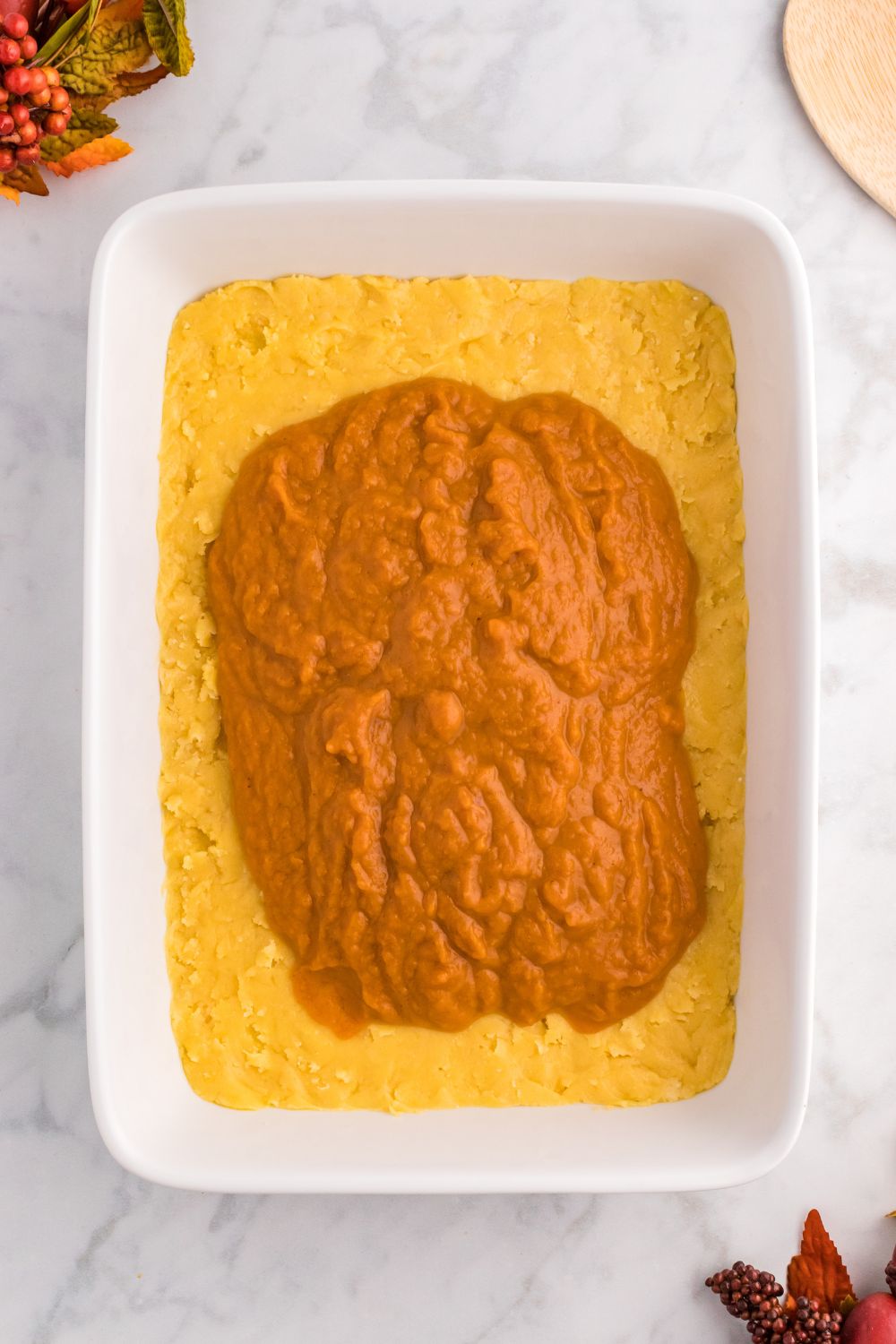 raw Pumpkin Pie Cake filling in pan on table 