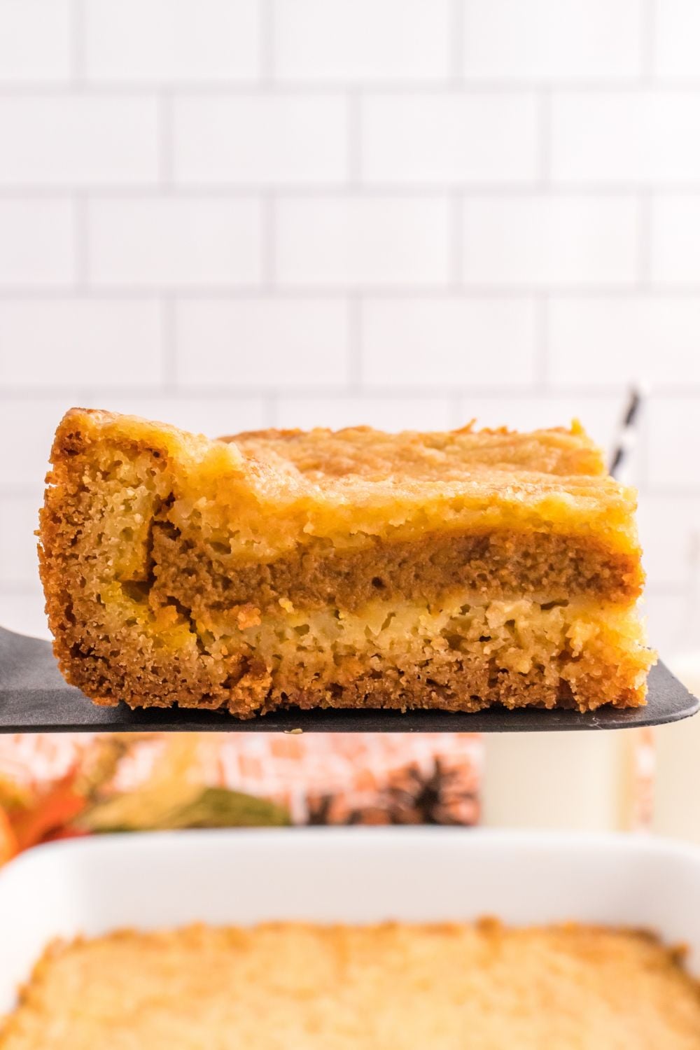 Pumpkin Pie Cake sliced on a spatula 