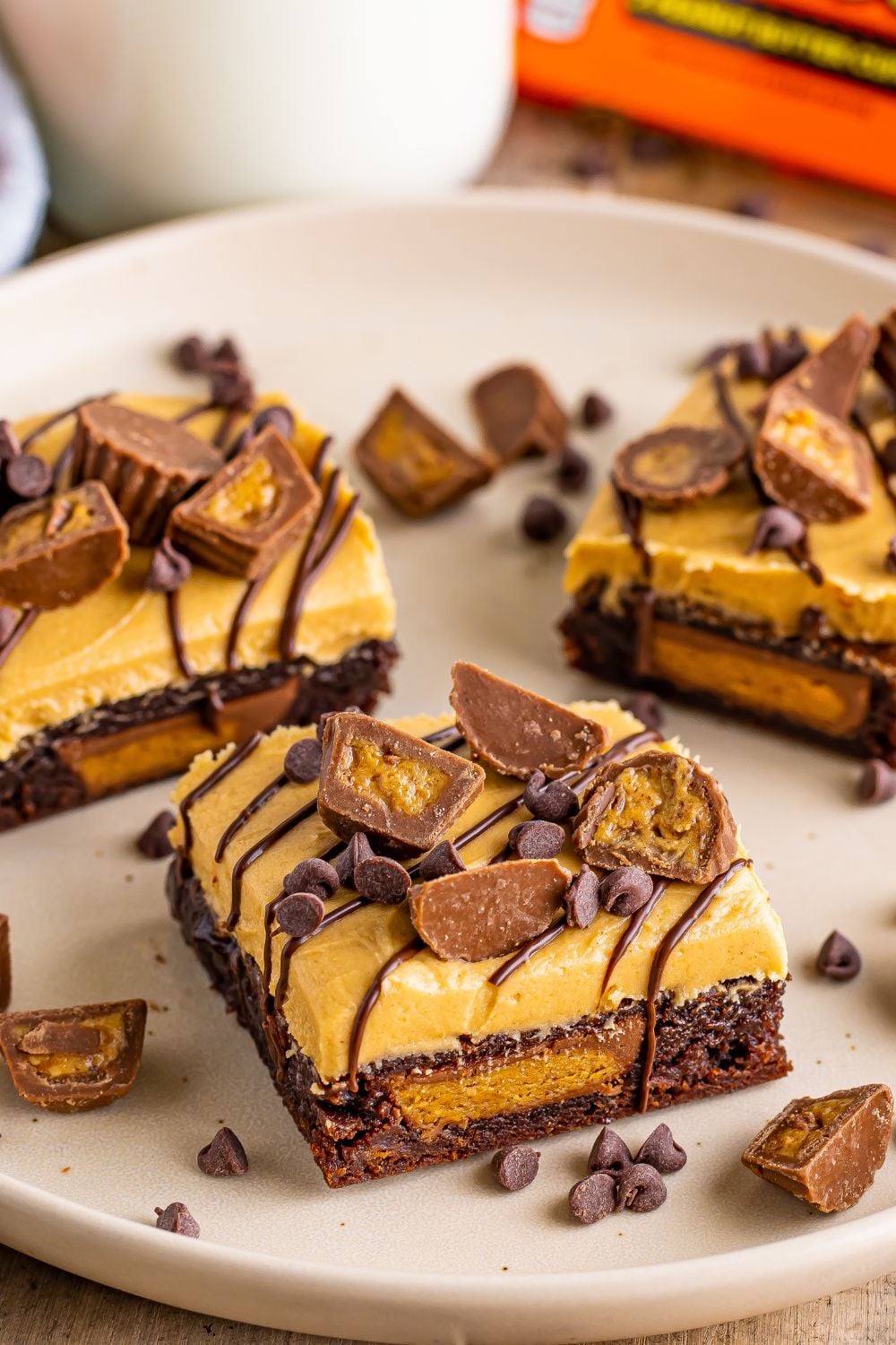 Reeses Stuffed Brownies sliced into squares and placed on a round plate on table