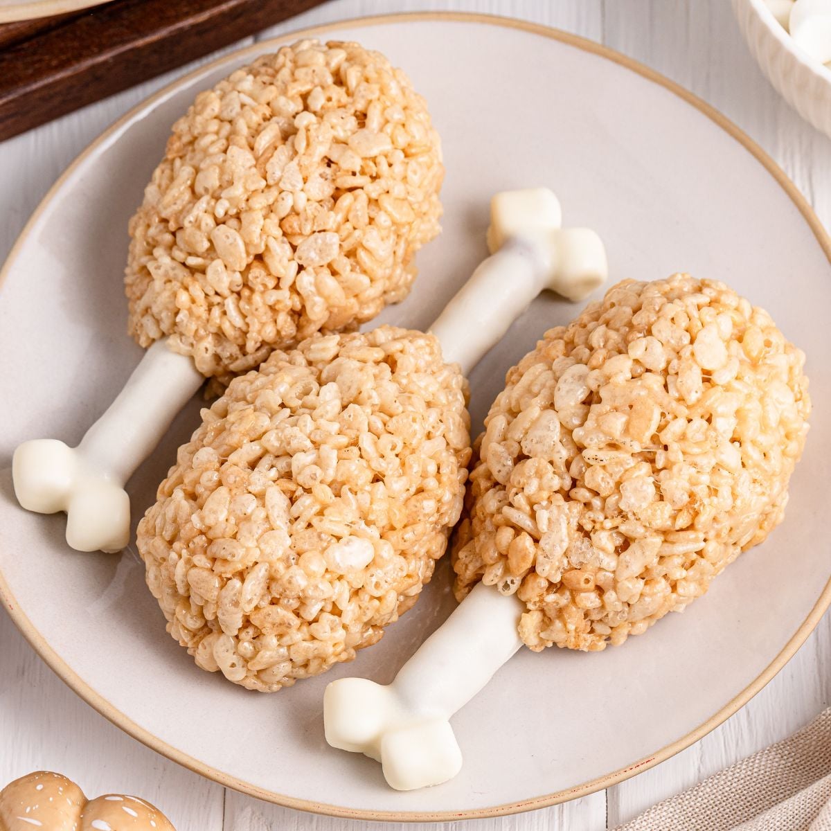 Rice Krispie Treat Turkey Legs on a white plate sitting on table