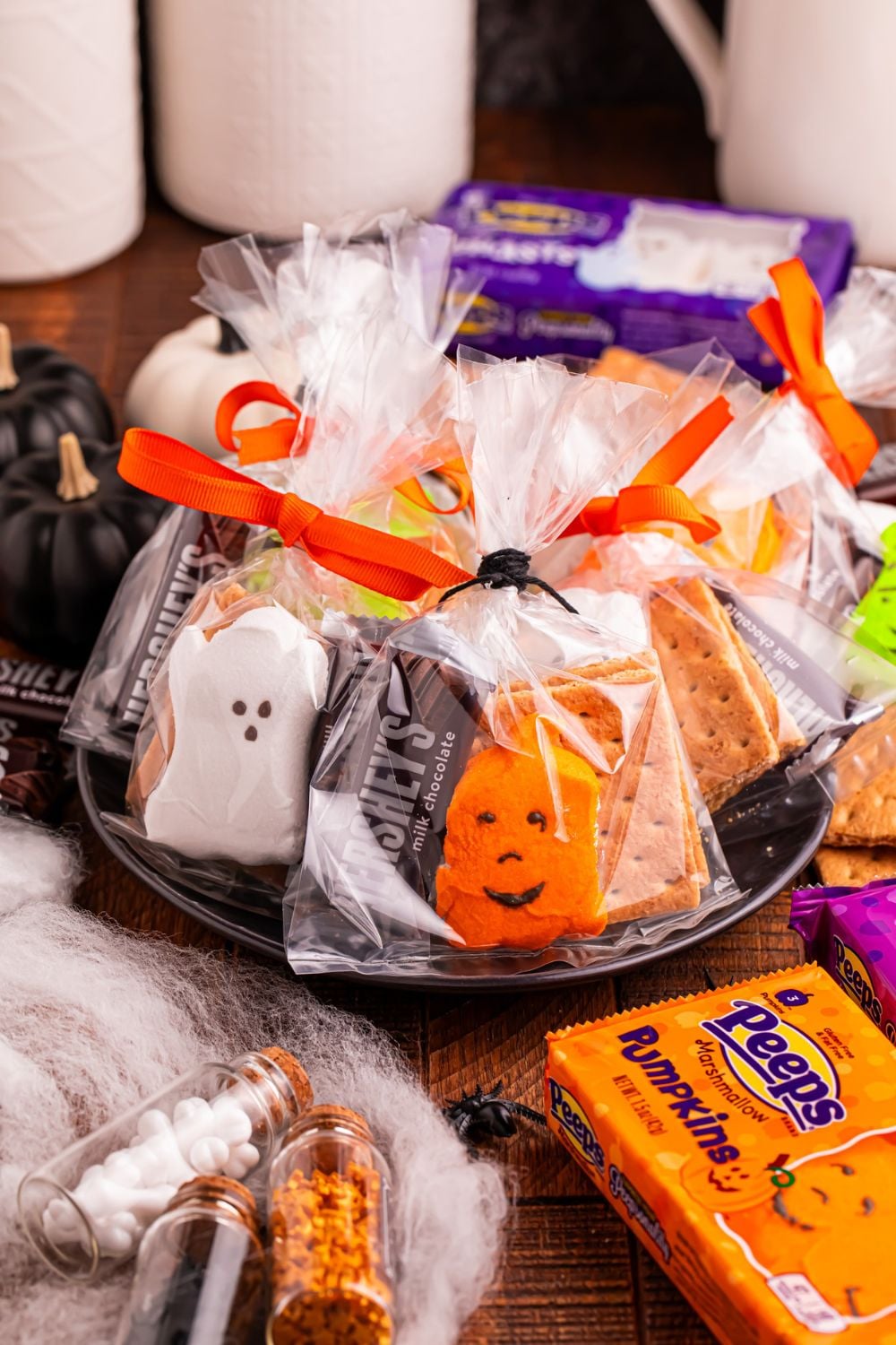 Halloween Smores Gift Bags on table with candy and other items around it to show items in each of the treat bags 