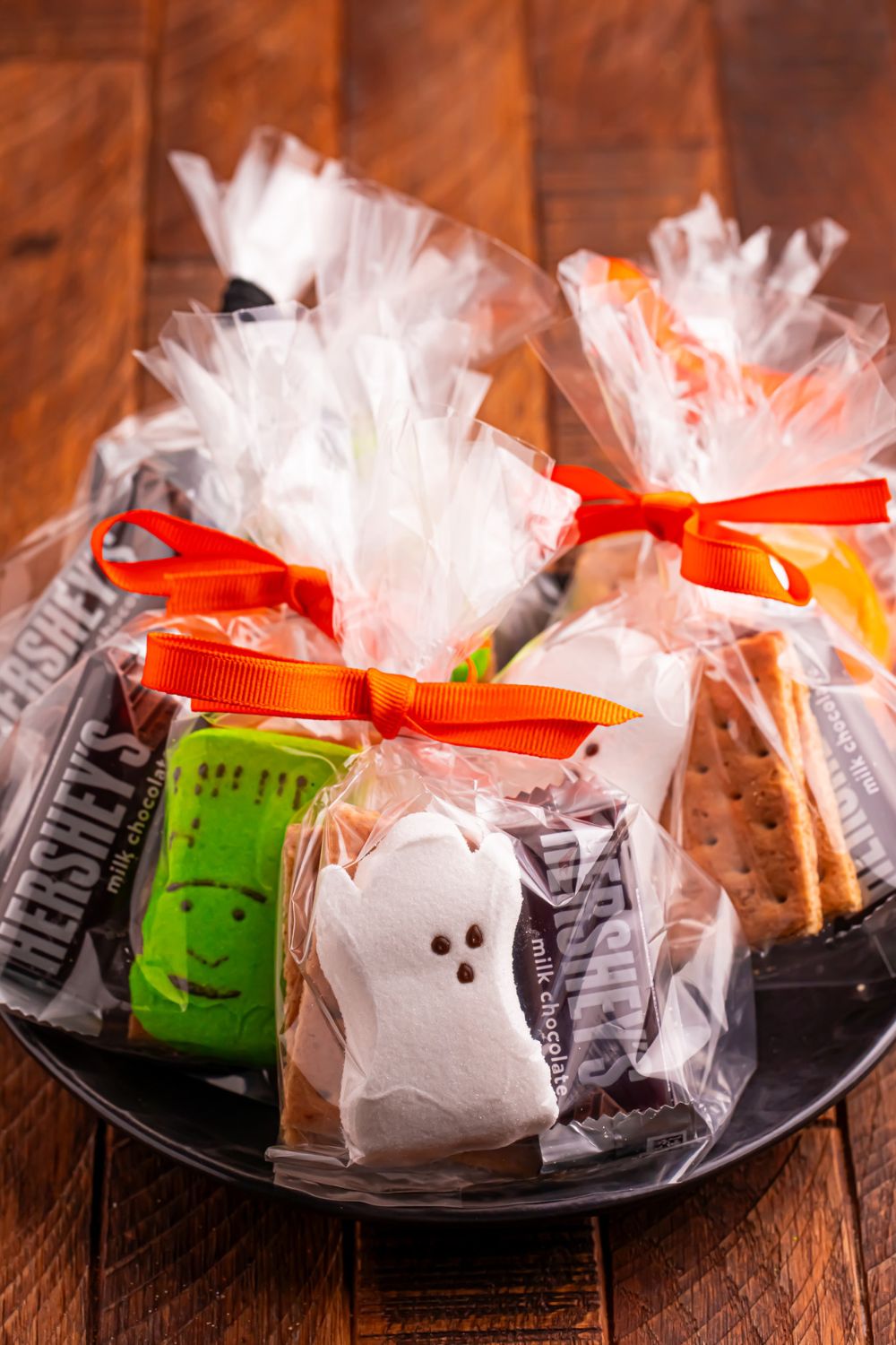 Halloween Smores Gift Bags in a black bowl on a wooden table 