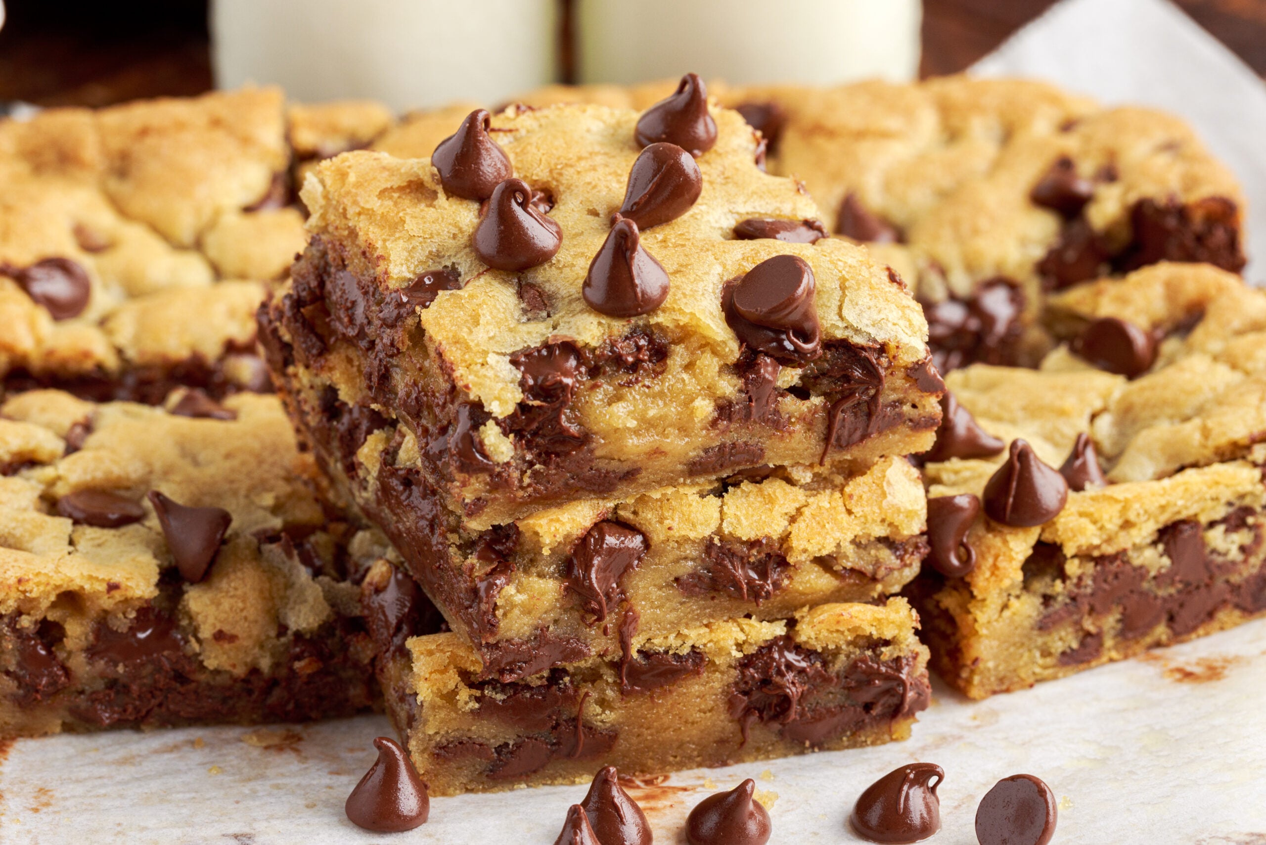 Side view of three stacked chocolate chip cookie bars.