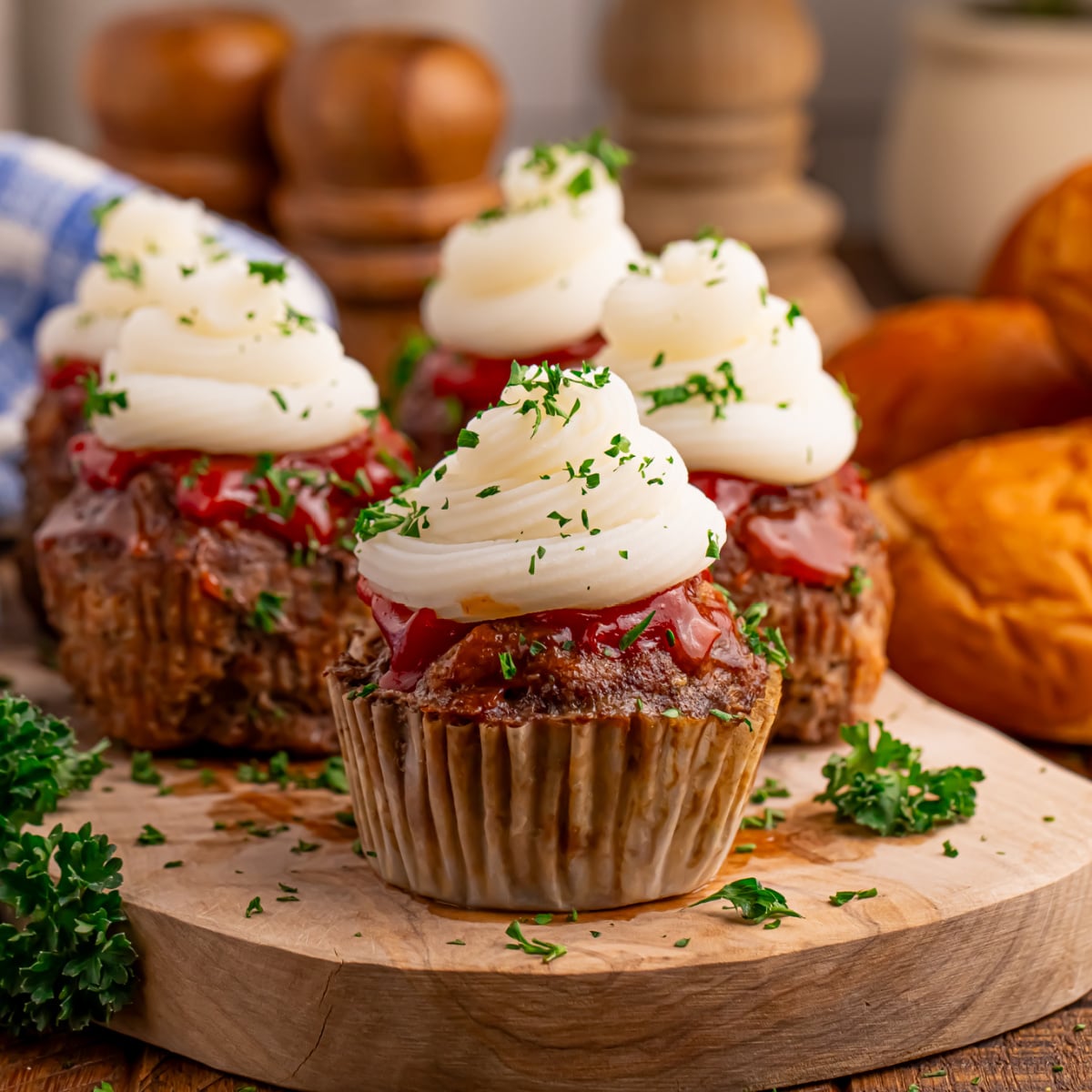 Meatloaf Cupcakes sitting on a wooden cutting board