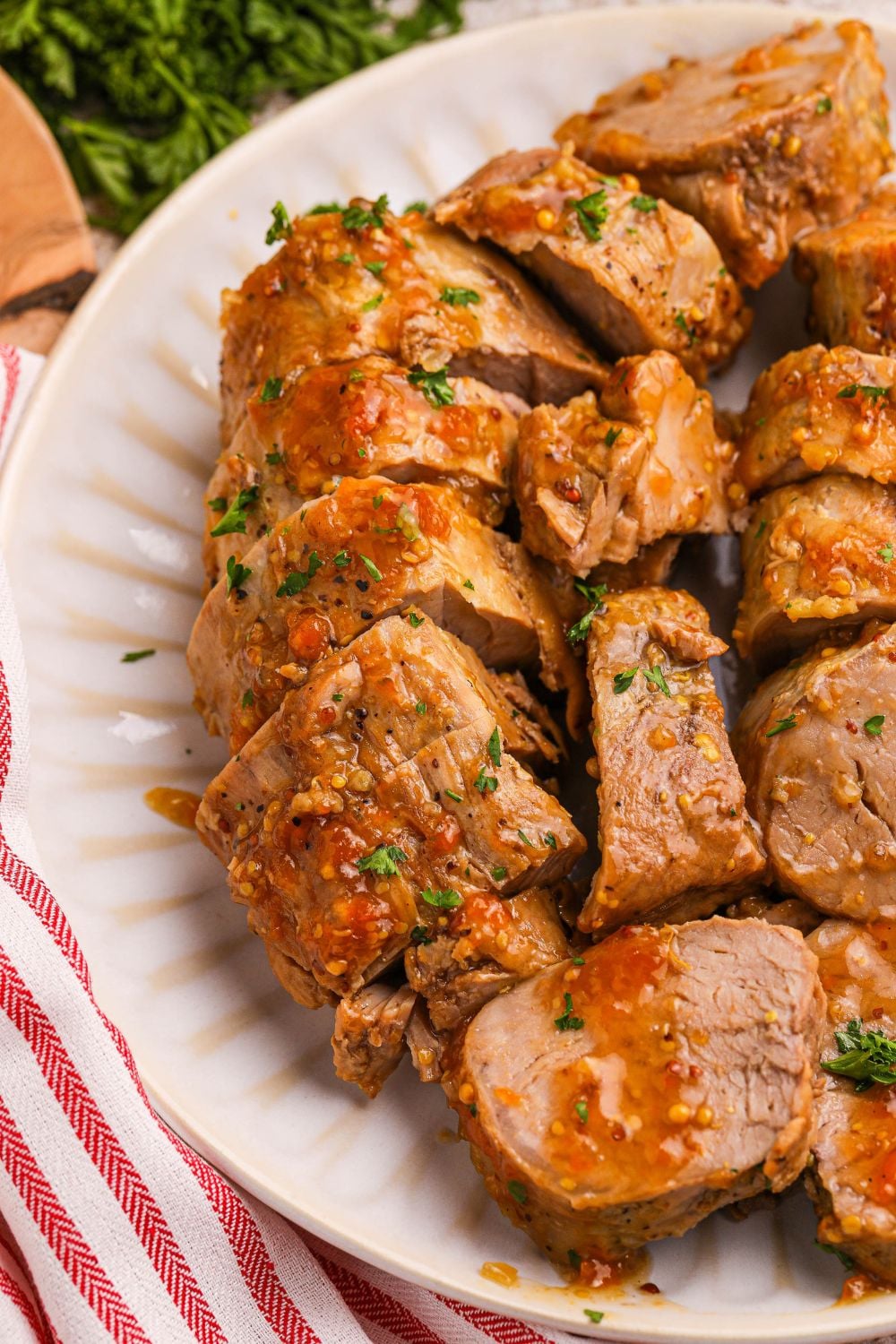 Crock Pot Apricot Pork Tenderloin sliced into medallions on a plate
