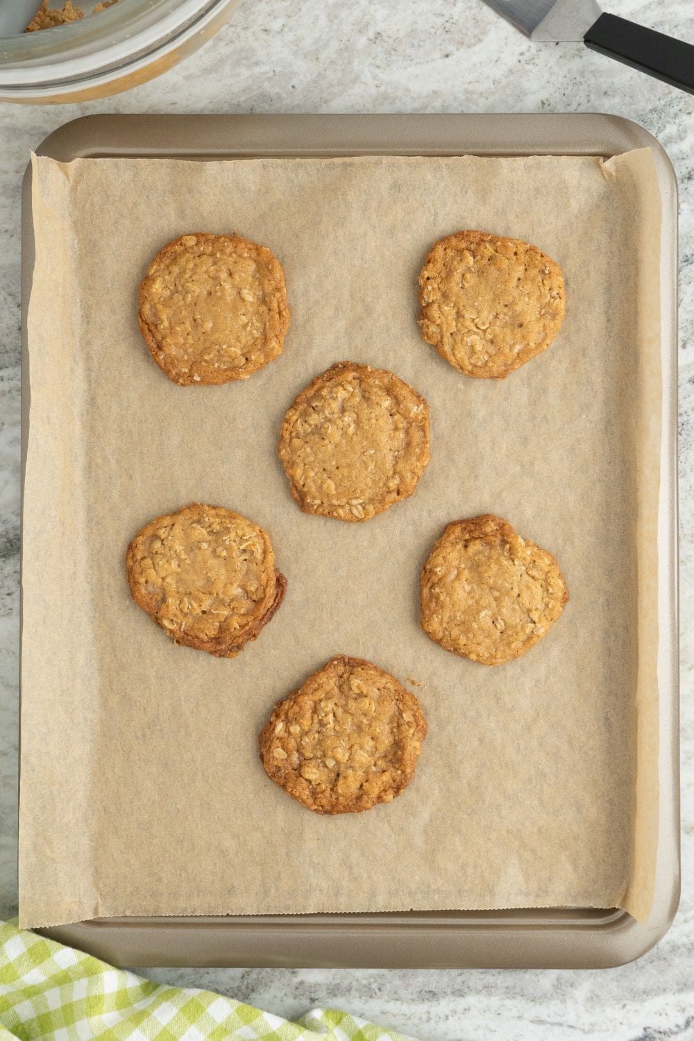 Oatmeal Toffee Cookies on a parchment lined baking tray 