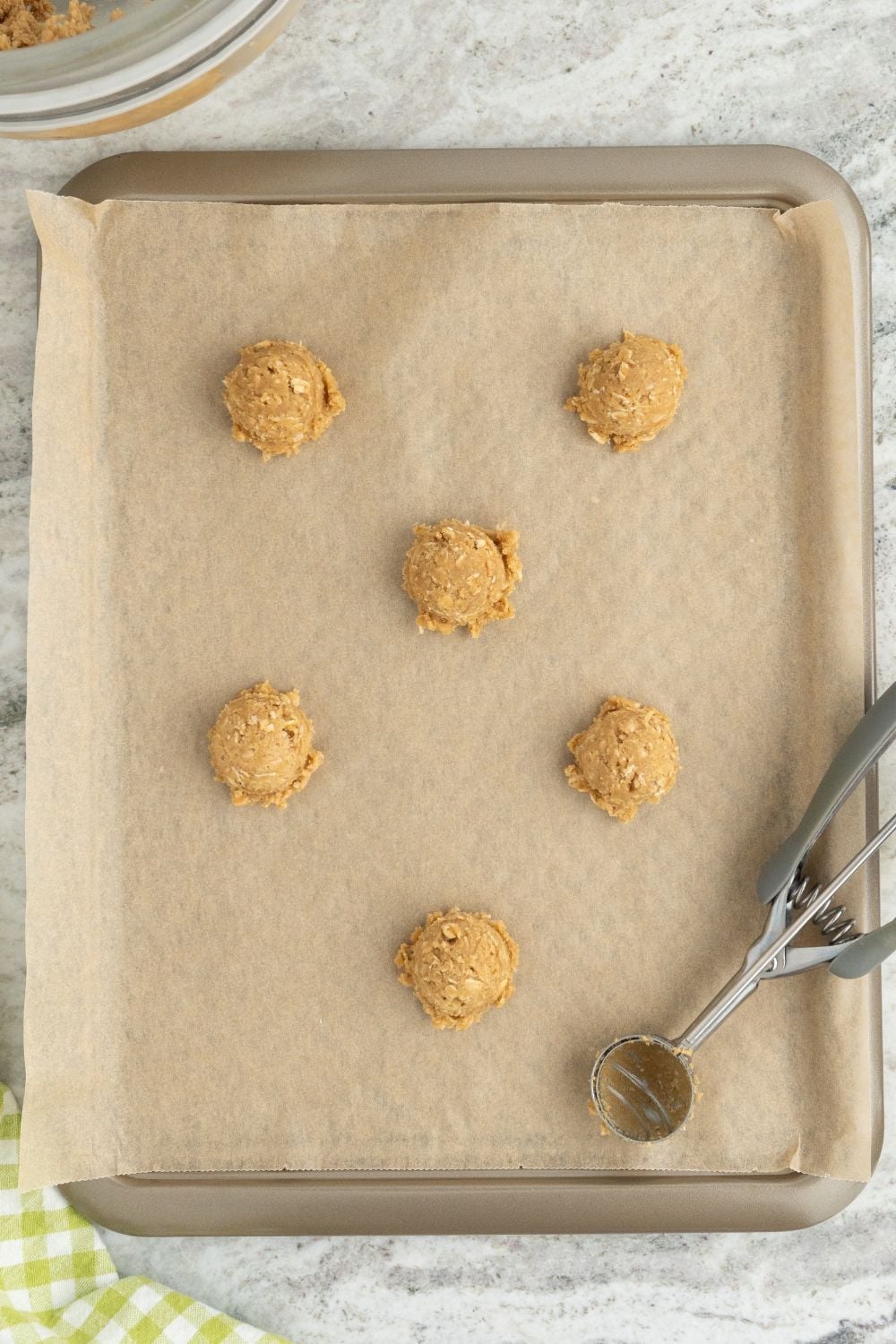 raw cookie dough on a parchment lined cookie sheet 