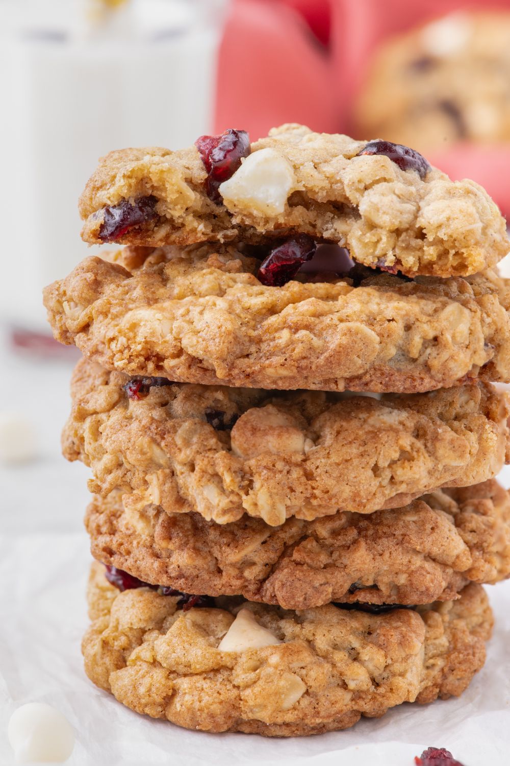 White Chocolate Cranberry Oatmeal Cookies stacked on plate with a few bites taken out of the top one