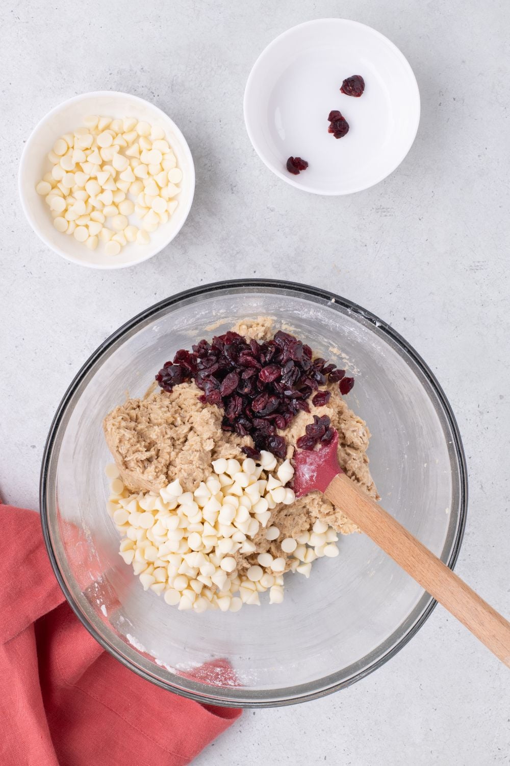 dried cranberries and white chocolate chips and White Chocolate Cranberry Oatmeal Cookie dough in a bowl on table