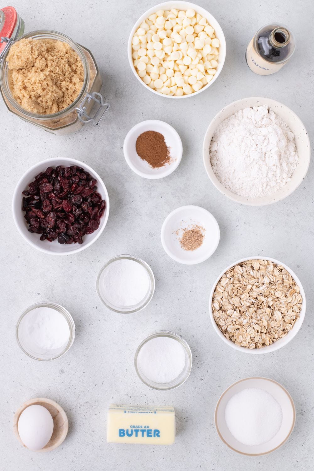 ingredients for cranberry oatmeal cookies on table in single serve bowls