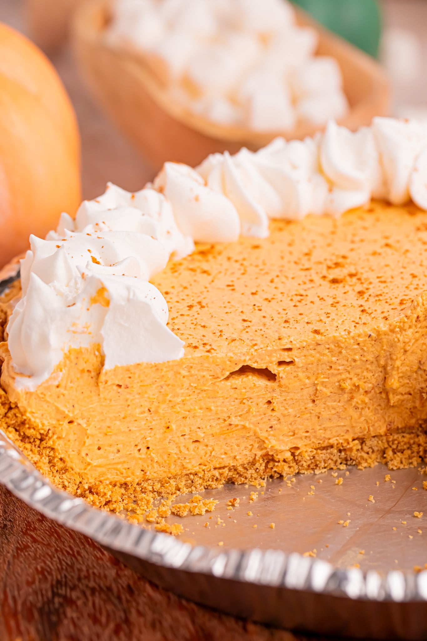 Marshmallow Pumpkin Pie in a pie dish with a slice removed