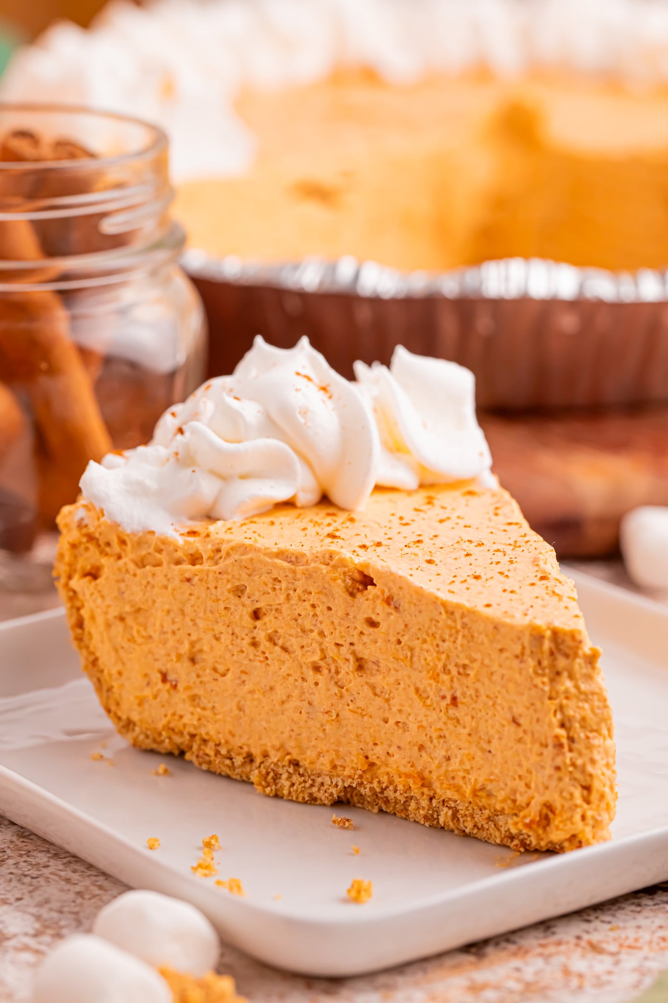 Side view of the Marshmallow Pumpkin Pie slice on a white plate