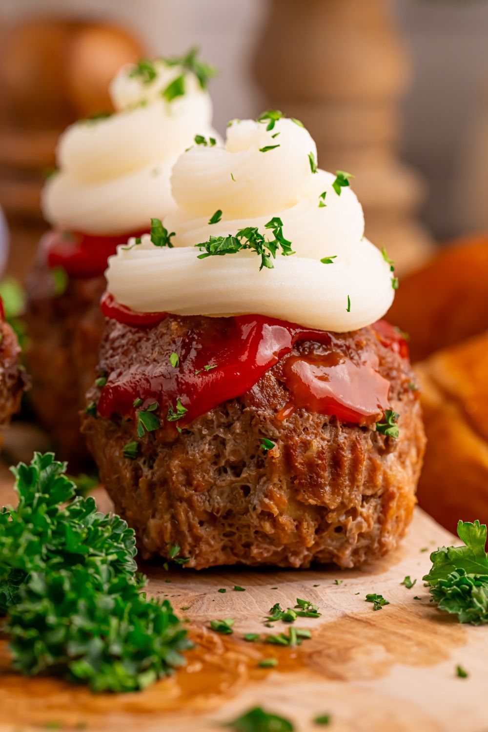 Meatloaf Cupcakes sitting on table with some parsley around it 