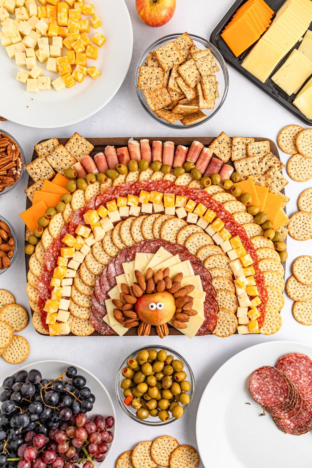 Turkey Snack Board on table with all types of the food around it on the table in bowls and plates