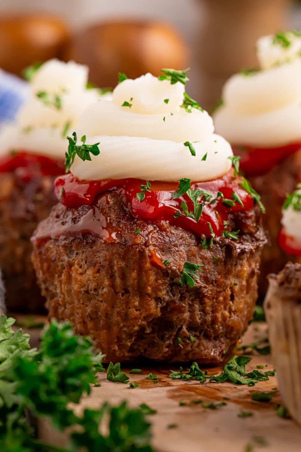 Meatloaf Cupcakes on table with parsley on the side for a pop of green in picture 