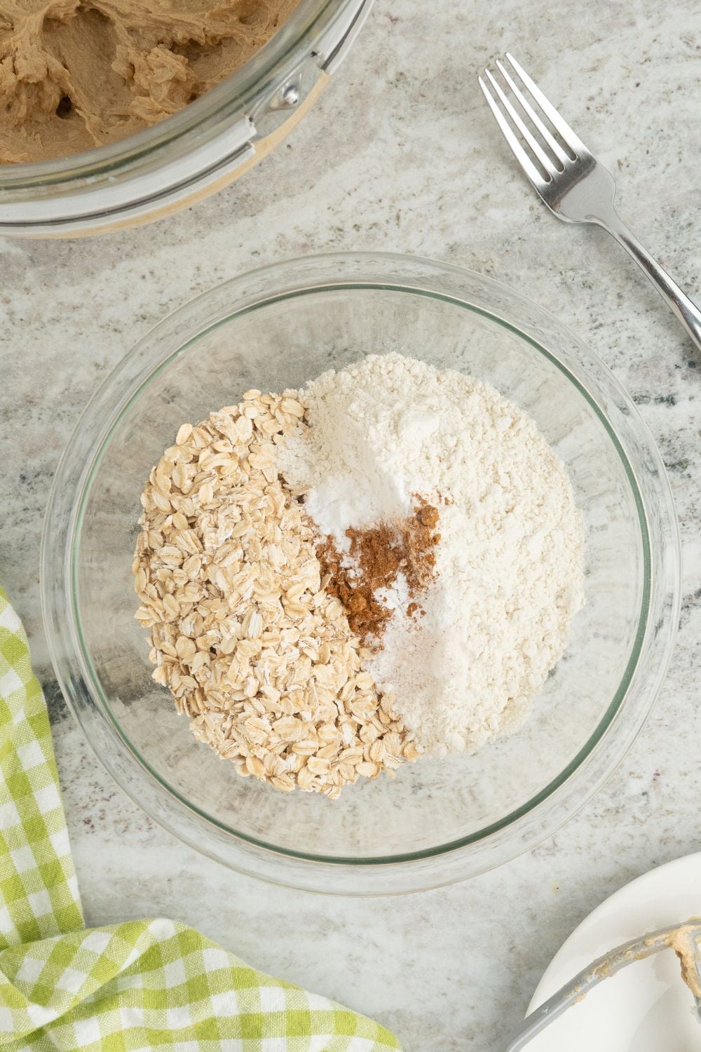 dry ingredients for Oatmeal Toffee Cookies in a glass bowl on table 