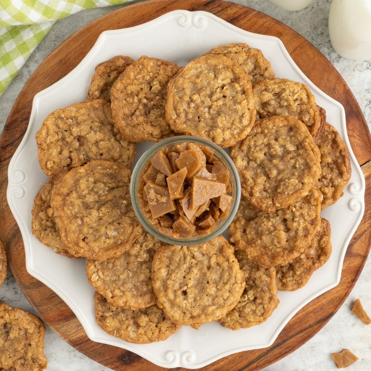Oatmeal Toffee Cookies on a plate with a bowl of toffee in the center of the plate 