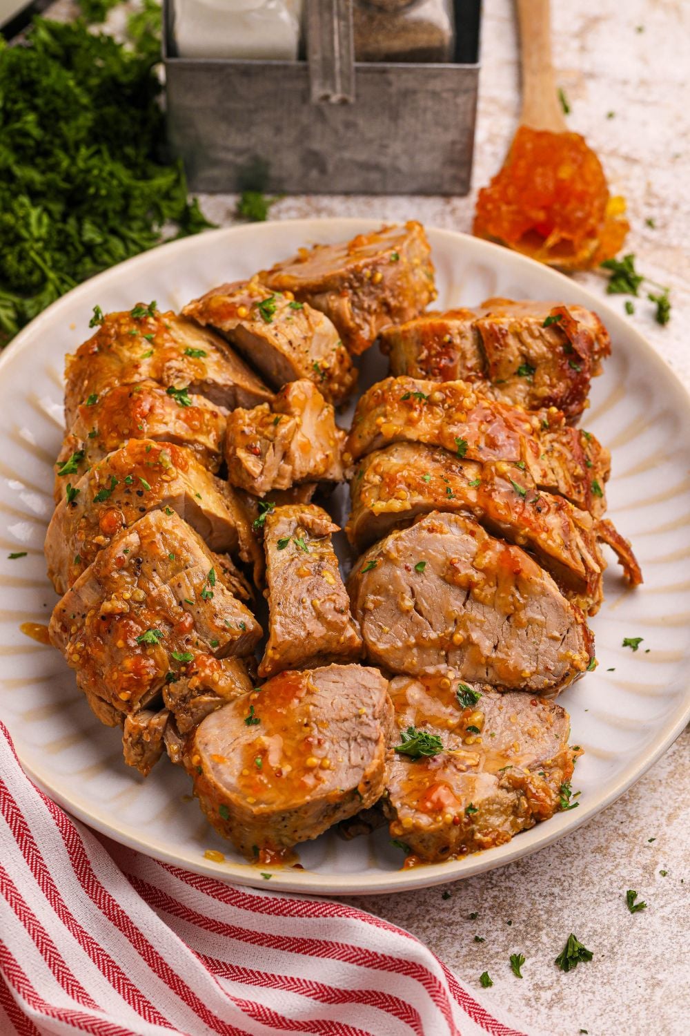 pork tenderloin with apricot sauce sliced and placed on a platter on table