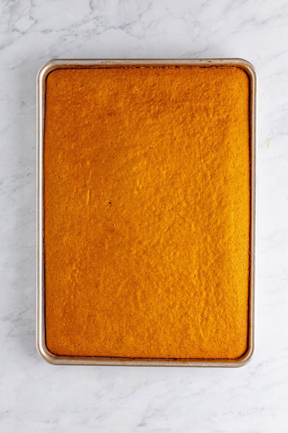 overhead look of a baked Pumpkin Snack Cake in pan on table