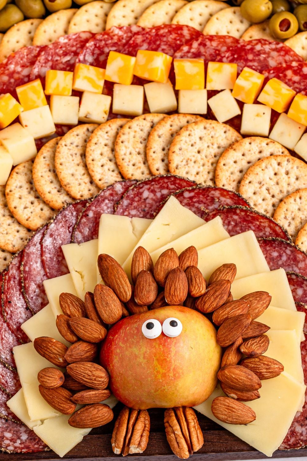 Thanksgiving snack board that looks like a turkey sitting on table