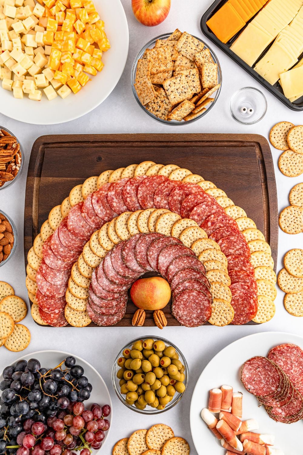 meat and crackers spread out on tray for making the Turkey Snack Board